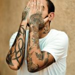 a man with tattoos on his face