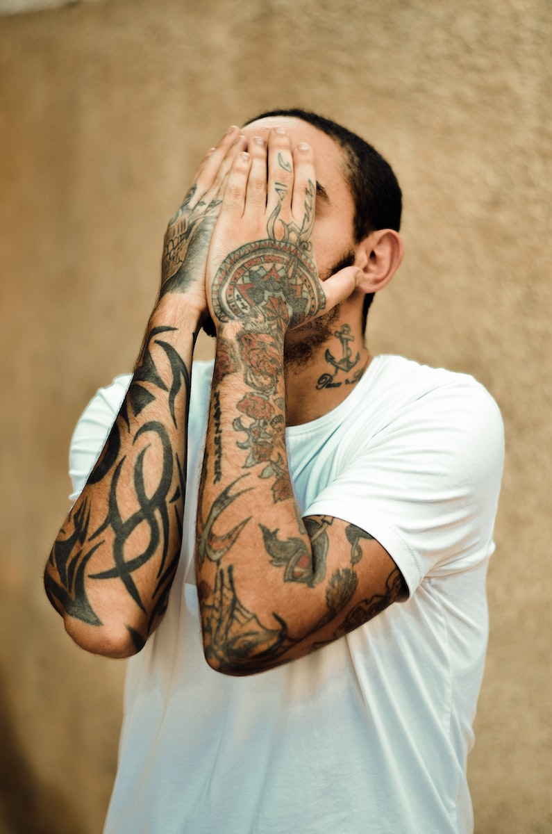 a man with tattoos on his face